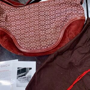 Coach, wine color suede, great bag! Includes interior drawstring bag, cards.